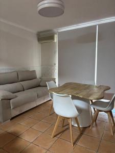 a living room with a table and a couch at La Esquina Mayor in Caravaca de la Cruz