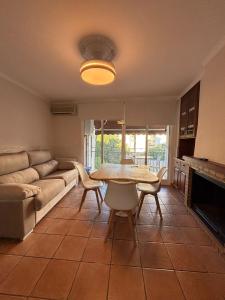 a living room with a table and a couch at La Esquina Mayor in Caravaca de la Cruz