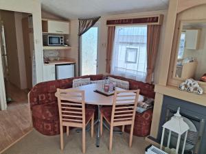 una sala de estar con una mesa y un sofá en Astounding Sea Views, en Bembridge 13 fotos más