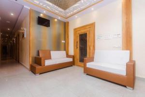 a room with two beds and a couch in it at Hotel Amber Sun City in Mumbai