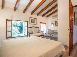 a bedroom with a large bed and a window at Can Gat in Pollença +23 photos