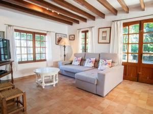 a living room with a couch and a table at Can Gat in Pollença