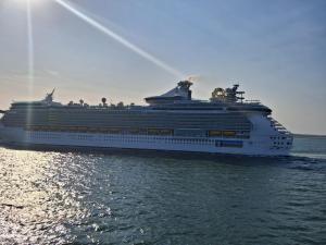 a cruise ship sitting in the water at Sandhills Holiday Park Astounding Sea Views in Bembridge