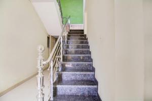 a flight of stairs in a white building at Hotel O Satyam Shree in Indore