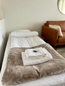 a room with two beds with towels on them at Your Lapland Sauna Stay in Rovaniemi