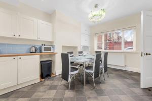 a kitchen with a table with chairs and a microwave at Convenient 2BR House with Free Street Parking in Middleton