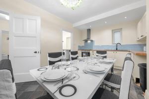 a dining room with a table with plates and silverware at Convenient 2BR House with Free Street Parking in Middleton +3 photos