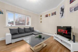 a living room with a couch and a tv at Convenient 2BR House with Free Street Parking in Middleton