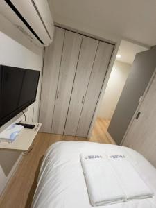 Postel nebo postele na pokoji v ubytování 秋の旅館