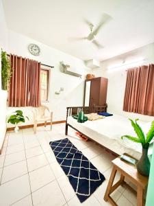 a bedroom with a large bed in a room at Serene Guest House ll 2 Ac Rooms ll WiFi ll Tv ll Garden in Khandala