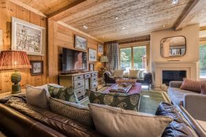 a living room with a couch and a fireplace at Apartment Au Bon Coin - Luxury Chamonix Hidden Haven, Mont Blanc view, Hot Tub and Garden in Chamonix-Mont-Blanc