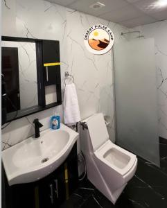 a bathroom with a white sink and a toilet at RUM BULSE BUBBLE lUXURY CAMP in Wadi Rum +42 photos