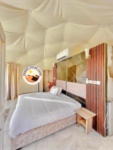 a bedroom with a bed in a tent at RUM BULSE BUBBLE lUXURY CAMP in Wadi Rum
