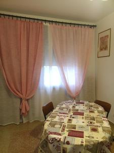 a table with a quilt on it in front of a window at Flat all for you in Treviso