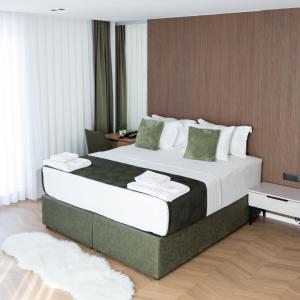 a bedroom with a large bed in a room at Hotel Ari Gjakove in Gjakove