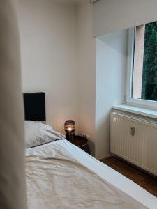 a bedroom with a bed and a window at Traunsee Design Apartment for 2 People in Gmunden +13 photos