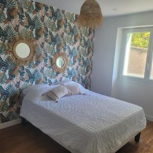 a bedroom with a bed with two pillows on it at Appartement standing proche centre rocade PARC colombiere wifi in Dijon