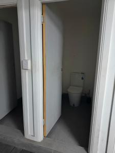 an open door to a bathroom with a toilet at Room in Hostel in Rockhampton