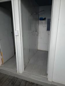 a bathroom with a shower with a glass door at Room in Hostel in Rockhampton