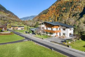 a house on the side of a road next to a mountain at Haus Galgenul by A-Appartments in Galgenul