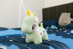 a toy elephant sitting on top of a bed at Cozy homestay Manhattan Ipoh,12 pax 怡保民宿 in Ipoh