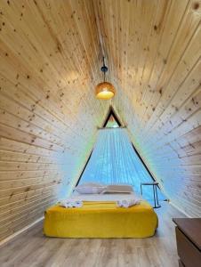 a bed in a wooden room with a tent at Romantic Villa 2BR by the Sea in Tsikhisdziri