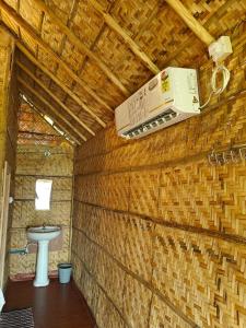 a bathroom with a toilet in a brick wall at The Sundown Hampi in New Hampi