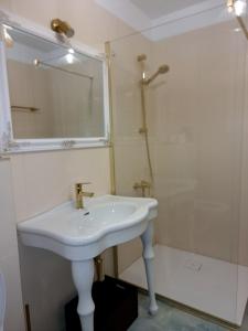 a white bathroom with a sink and a shower at GLAMOUR VOX Jacuzzi & Club in Cluj-Napoca +29 photos