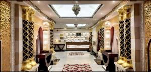 a dressing room with gold columns and a skylight at Procare Apart hotel in Jeddah +61 photos