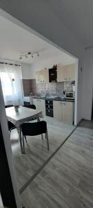 a living room with a table and a kitchen at Apartament Edy in Orşova