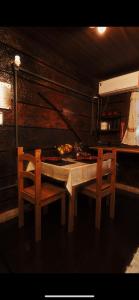 a kitchen with a table with two chairs and a stove at Pousada GPC in Macaé +29 photos