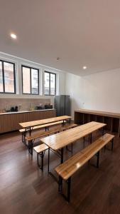 a row of wooden tables in a room at Porto Hostel Cúpula in Porto +36 photos