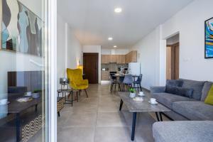 a living room with a couch and a table at Hilltop 2-Bedroom Apartment in Larnaca +9 photos