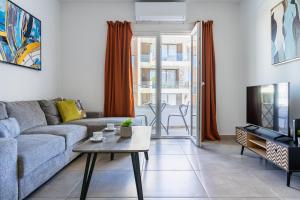 a living room with a couch and a table at Hilltop 2-Bedroom Apartment in Larnaca