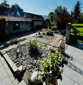 a garden with rocks and plants in front of a house at Sabes Ferienwohnung in Altglandorf +14 photos
