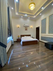 une chambre avec un grand lit et un parquet dans l'établissement Chanar Spring Meadows, à Lahore