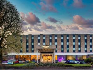 a hotel building with cars parked in front of it at Mercure Nottingham Sherwood in Nottingham