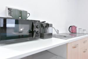 a microwave oven sitting on a kitchen counter at LHE Les Trois Meirvelles - Green Fernando in Cesena