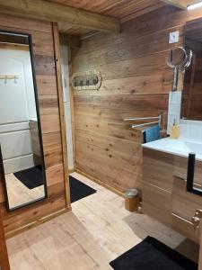 a small bathroom with a mirror and a sink at Le Chalet Atypique in Saint-Pierre +24 photos