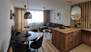 a living room with a couch and a table at Apartament Opawska 2 in Gliwice
