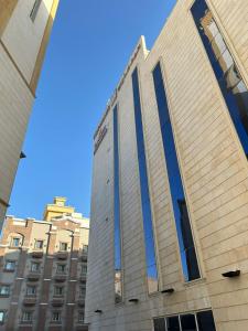 a tall building with a blue sky in the background at Toot house Jeddah in Jeddah