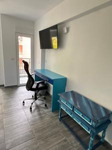 a blue desk and a chair in a room at Бутик хотел ресторант брасери и релакс зона Сажитариус in Kyustendil +57 photos