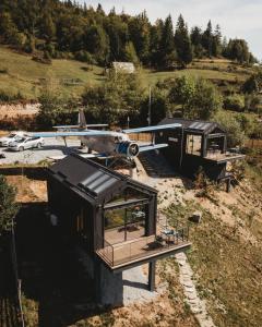a house with a plane sitting on top of it at Apuseni Air - Luna in Mătişeşti