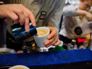 a person is making a cup of coffee at Mercure Timisoara in Timişoara