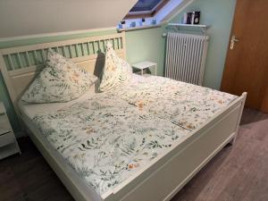 a bed with two pillows on it in a bedroom at Eifelnest Stadtkyll in Stadtkyll
