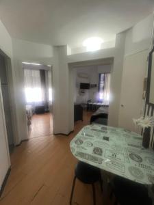a room with a table and a living room at Corazón obelisco 3 in Buenos Aires