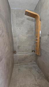 a bathroom with a shower with a stone wall at Oasi Cleopatra Luxury Suite B&B Puglia Salento in San Pietro in Bevagna