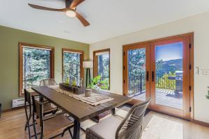 a dining room with a table and chairs and windows at RollinsVilla home in Rollinsville