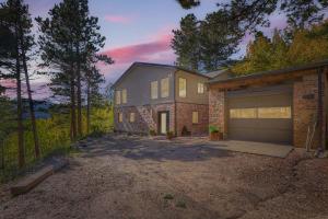 a house with a garage in front of it at RollinsVilla home in Rollinsville