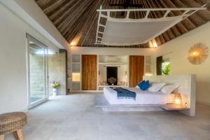a bedroom with a large bed in a room at OMAÏA Private villas in Amed